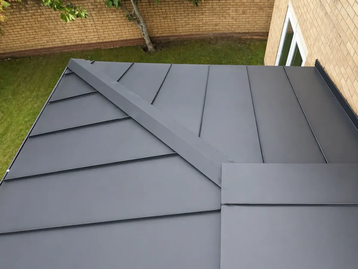 Zinc roof with diagonal standing seam pattern at a roof junction
