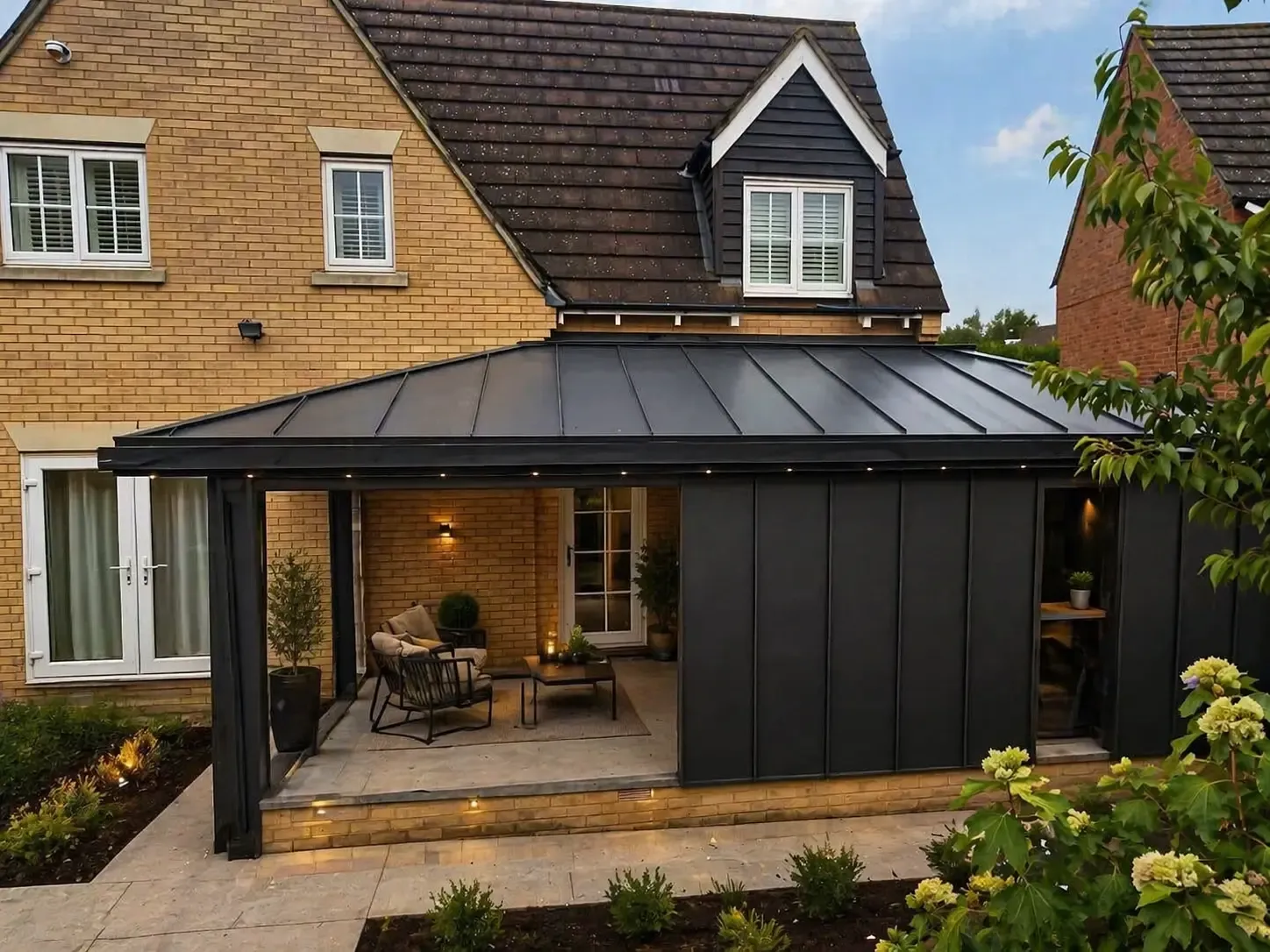 Dark zinc canopy roof over a rear extension with open seating area